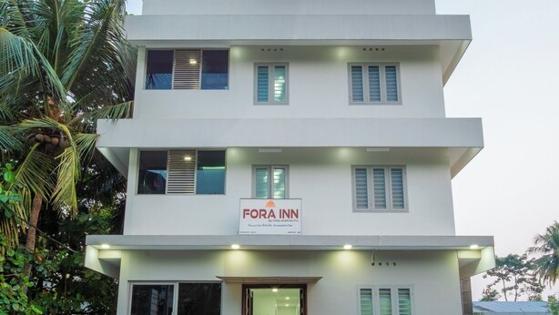A multi-story building with a sign reading "FORA INN". - FORA INN (Kanayannur)