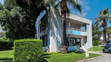 A two-story building with a modern design, featuring a balcony on the upper floor.