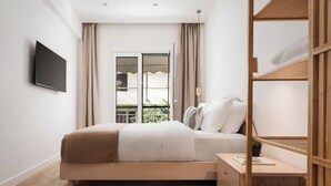 A modern bedroom with a bed, bedside table, and a TV mounted on the wall. - Athenian Hillside Apartment, Apartment (Athens)