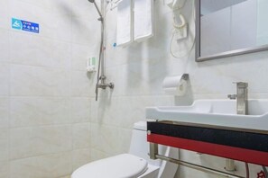 A bathroom with a white toilet, a sink with a red and black stripe, a mirror, and a shower head. - Jiazhou Shishang apartment (Guangzhou Airport North Gate) (Guangzhou)