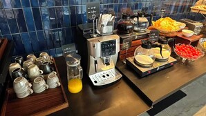 A coffee station with multiple coffee makers, a coffee pot, and a variety of coffee cups and mugs. - The Yun Collection  Yongqingfang  (Guangzhou)