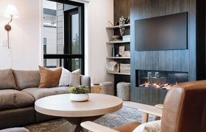 Smart TV, fireplace - Experience Revelstoke from Four Peaks Penthouse, a bright and modern 3-bedroom mountain escape. (Revelstoke)