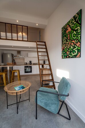 A modern kitchen with white cabinets, a stainless steel range hood, and a coffee machine. - The cove - 4P - Charming apartment - Sea view (Martigues)
