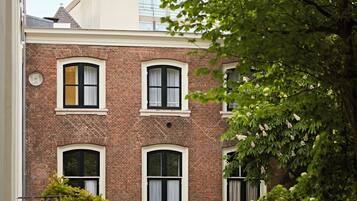 A brick building with multiple windows and a visible door.
