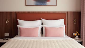 A hotel room with a bed, two nightstands, a wall-mounted painting, and a door with a handle.