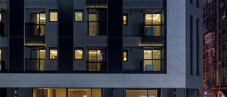 A multi-story hotel with a modern facade, large windows, and a prominent hotel sign.