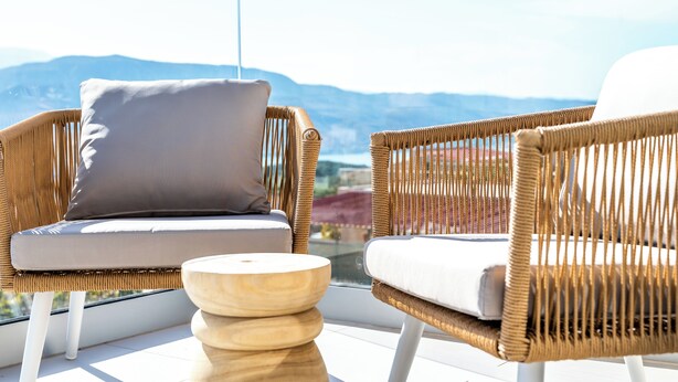 A balcony with wicker chairs and a wooden table, overlooking a mountainous landscape. - Elpida Luxury Villa, Private Pool, Fantastic View (Chania)