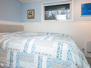 A bedroom with a bed, a window, and a wall-mounted picture. - 4 Star Holiday Home in Bording (Bording)