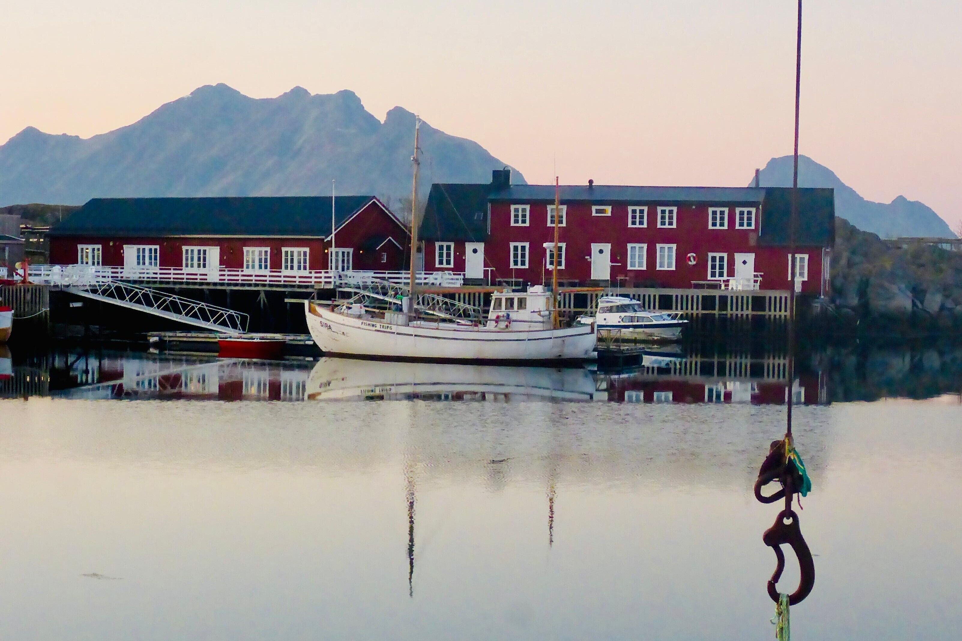A waterfront building with a dock and a boat.