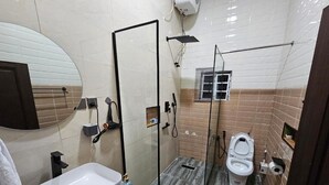 A bathroom with a sink, toilet, and shower area. - Meros Villa Apartment (Lagos)