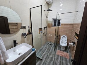 Ein Badezimmer mit Waschbecken, Toilette und Duschbereich.