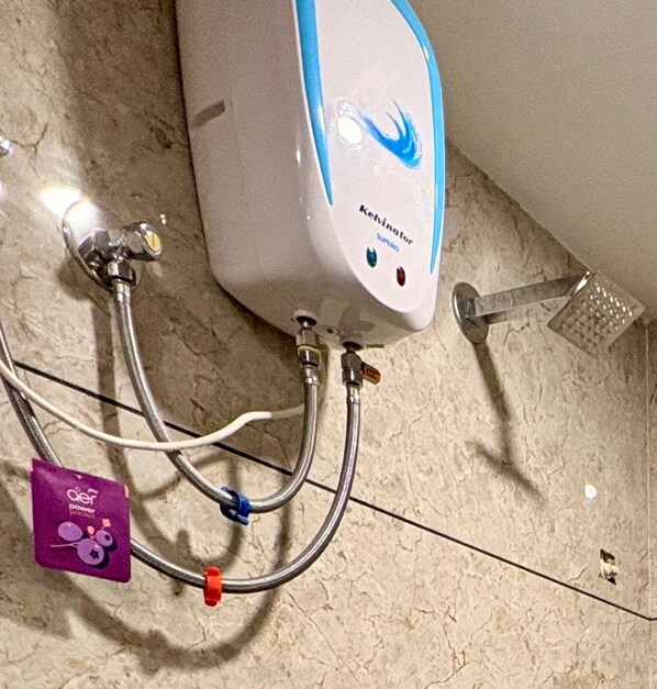 A bathroom with a white and blue water heater, multiple pipes, and a purple package labeled "aer power". - Aesthetic 1bhk luxe Indore (Indore)