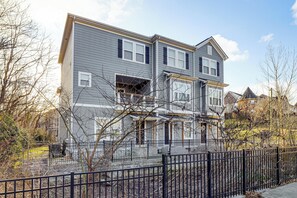 A two-story residential building with a grey exterior and black window shutters. - 6 Mi to Broadway: Nashville Townhome w/ Balcony! (Nashville)