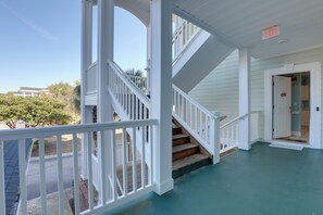 A covered porch with a staircase leading to a second floor. - < 5 Mi to Private Beach Access! Myrtle Beach Condo (Myrtle Beach)