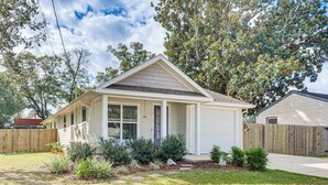 A single-story house with a front porch, a wooden deck, and a well-maintained lawn. - < 2 Mi to Dtwn! Quiet Family Home in Pensacola (Pensacola)