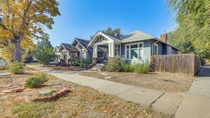 A suburban house with a front yard, a wooden fence, and a driveway. - Walk to Colorado College & Dwtn! Home w/ Patio (Colorado Springs)