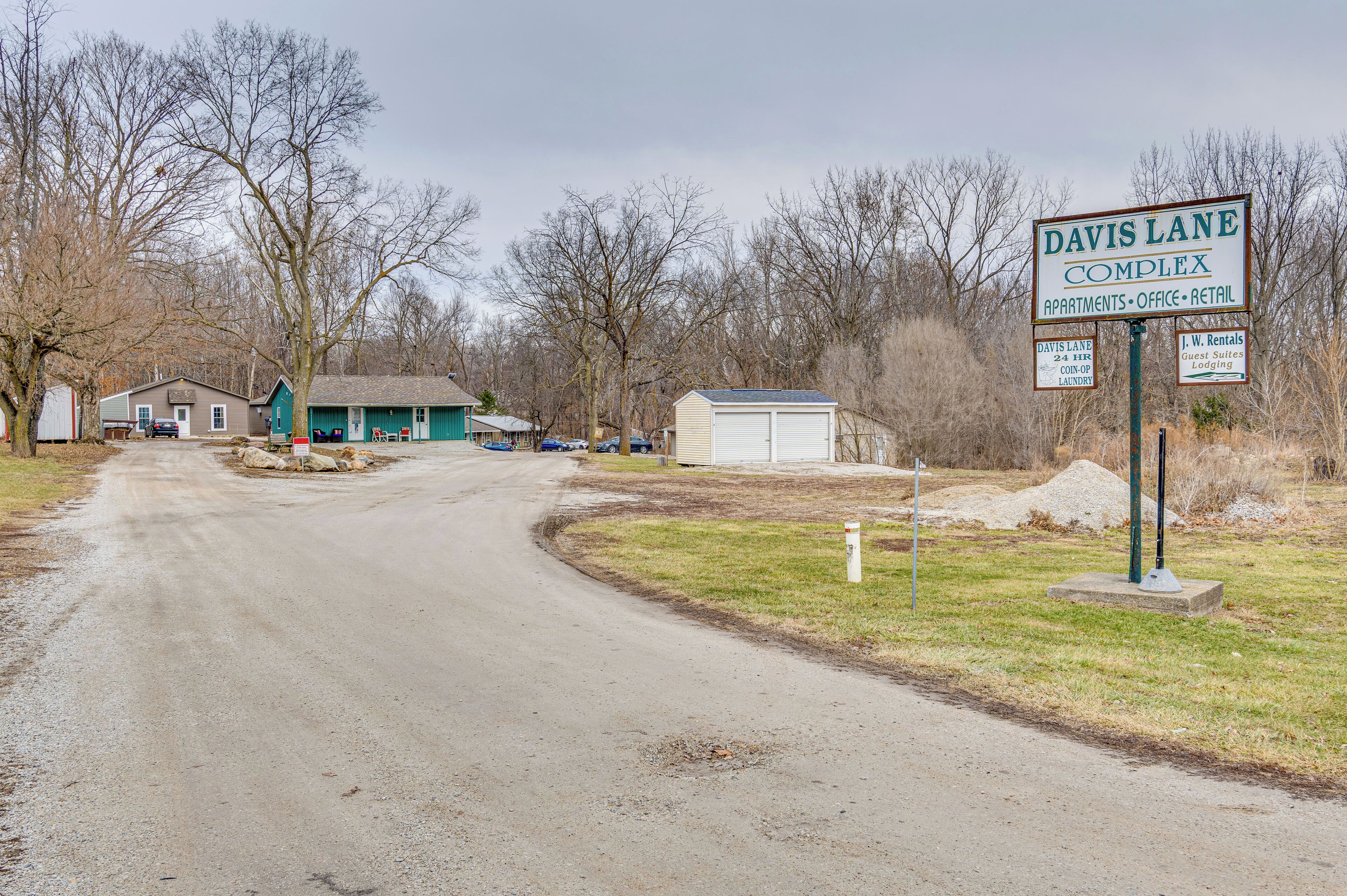 A sign for Davis Lane Complex with amenities including apartments, office, and retail.