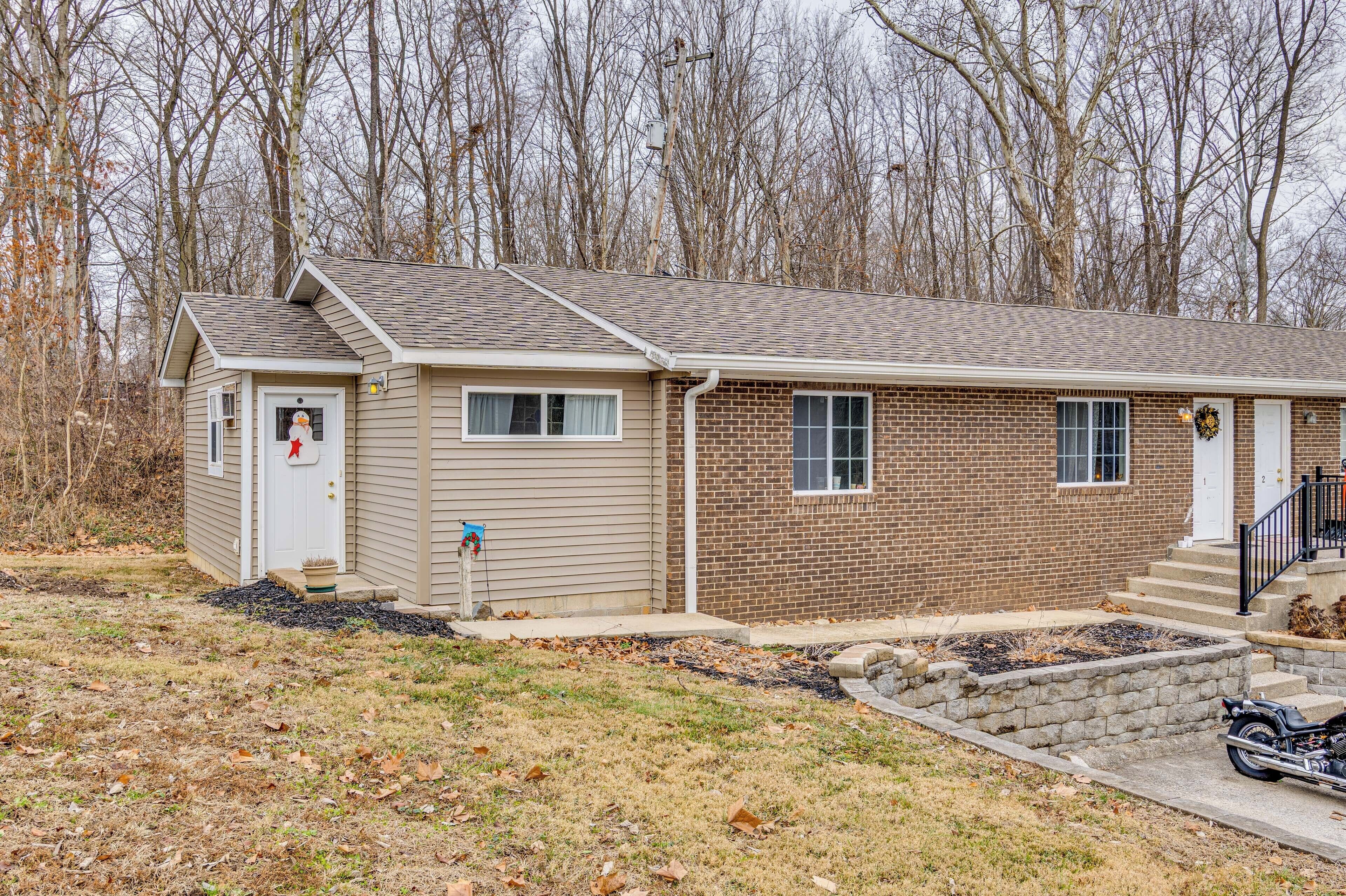 A single-story house with a brick exterior and a small attached garage.