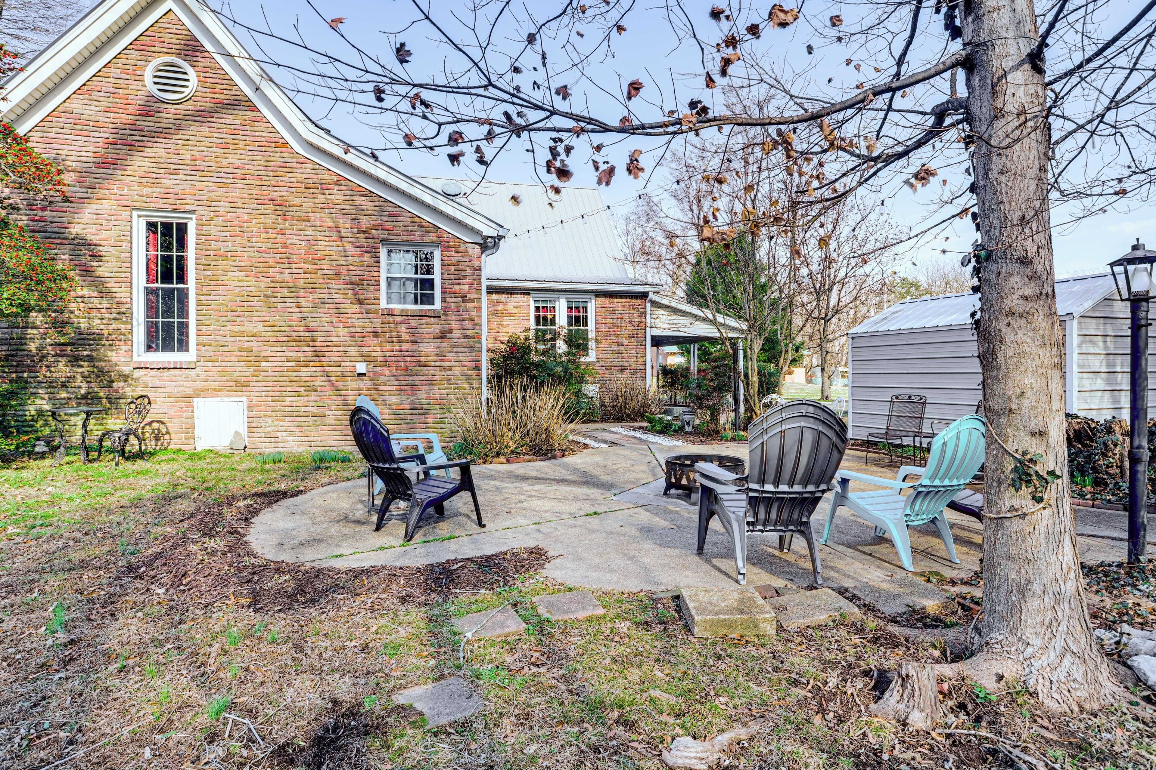 A brick house with a patio area featuring outdoor furniture.