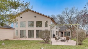 A two-story house with a covered patio area. - Woodburn Group Getaway: Endless On-site Fun! (Harlan)
