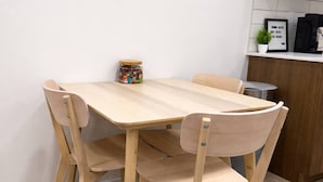 A wooden dining table with four chairs, a small potted plant, and a framed quote on the wall. - Condo w 2 Beds 13 Mins From West Edmonton Mall (Edmonton)