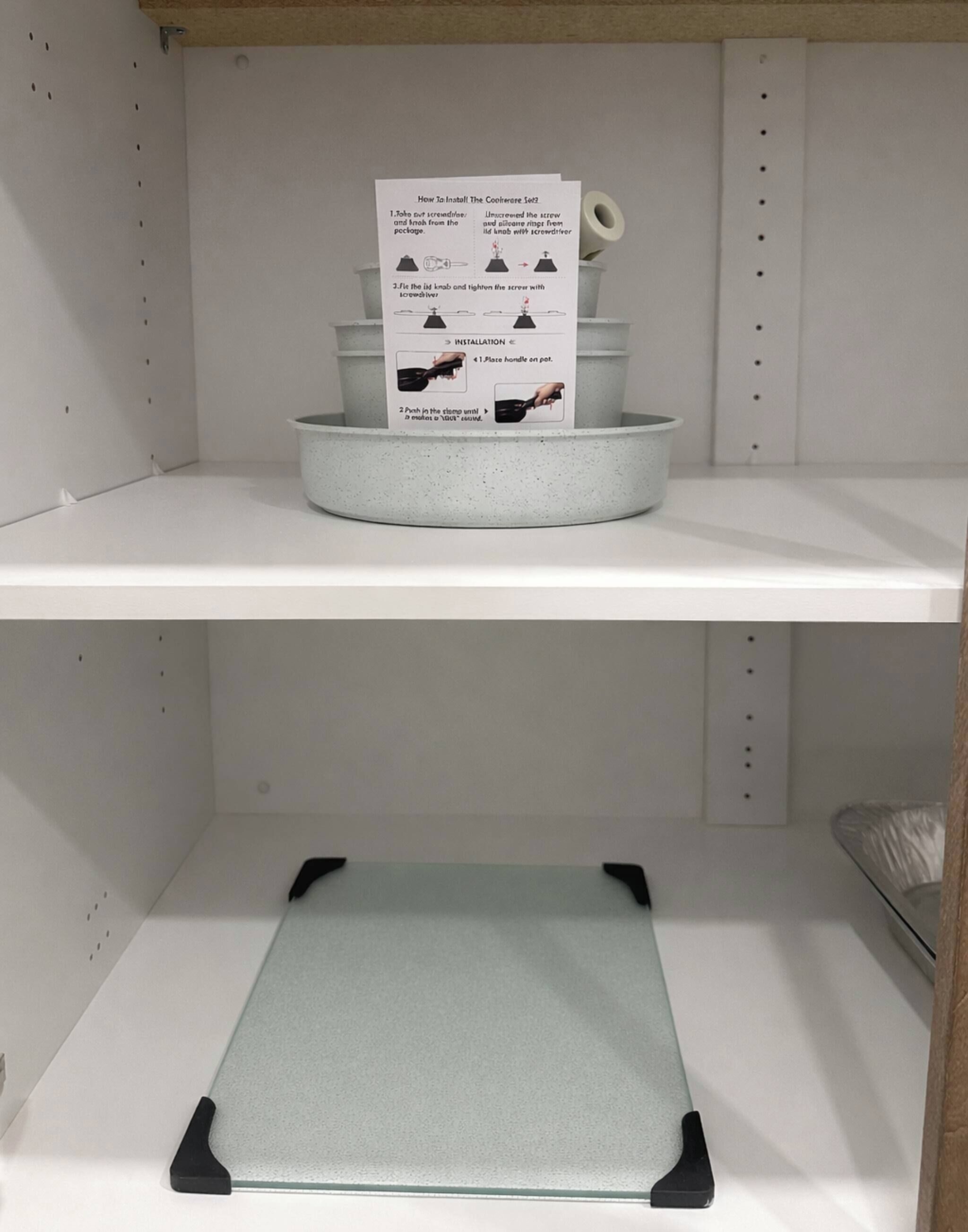 A shelf with a set of cookware and a placemat.