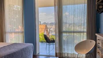 Suite Deluxe, balcón, vistas al mar | Tabla de planchar con plancha y wifi gratis