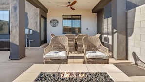 An outdoor patio with wicker furniture, a ceiling fan, and a fire pit. - Chill And Grill Getaway 4 Bedroom Townhouse (Washington)