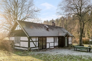 A traditional half-timbered house with a sloped roof, a chimney, and a small porch. - Charming Country Home in Scenic Österlen (Brösarp)
