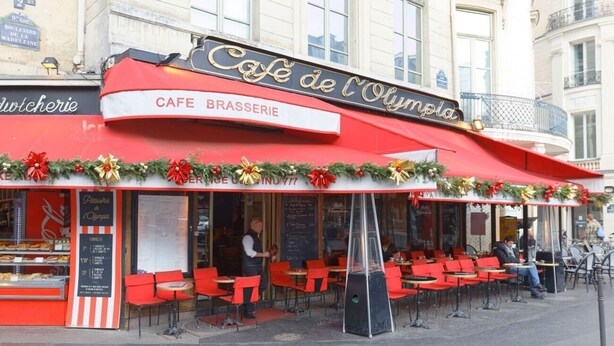 A cafe with outdoor seating, a red awning, and Christmas decorations. - JUST STEPS FROM LA MADELEINE & THE ICONIC FAUBOURG SAINT-HONORÉ (Paris)