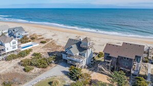 A coastal residential area with beachfront properties, including houses with balconies and a swimming pool. - Oceanfront, Dog Friendly Home in Avon with Private Swimming Pool and Hot Tub (Avon)