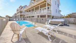 A wooden deck with a pool, lounge chairs, and a hot tub. - Oceanfront, Dog Friendly Home in Avon with Private Swimming Pool and Hot Tub (Avon)
