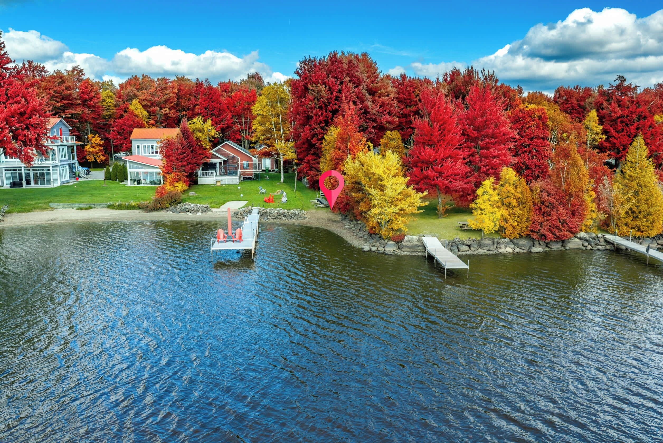 A lakeside property with a dock, a house, and a boat.