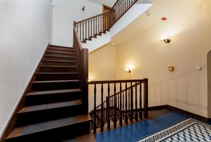 A staircase with wooden steps and a handrail, leading to an upper floor. - Malila Premium Apartments Cracow Grodzka (Kraków)