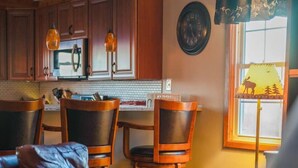 A cozy living room with a sofa, chairs, and a dining area with a table and chairs. - Monroe Retreat with Mountain Views & Fire Pit! (Monroe)