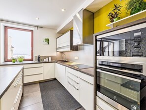 Een koelkast, een magnetron, een oven, kookgerei, borden en bestek
