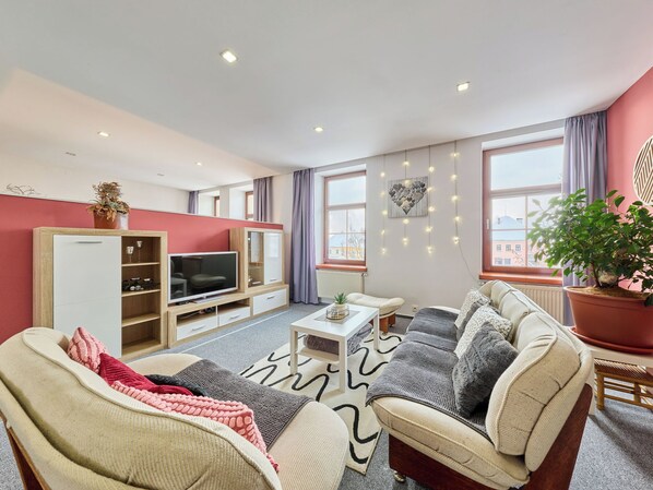 A modern living room with a sofa, TV, and a dining area. - Vysoké nad Jizerou by Interhome (Vysoké nad Jizerou)