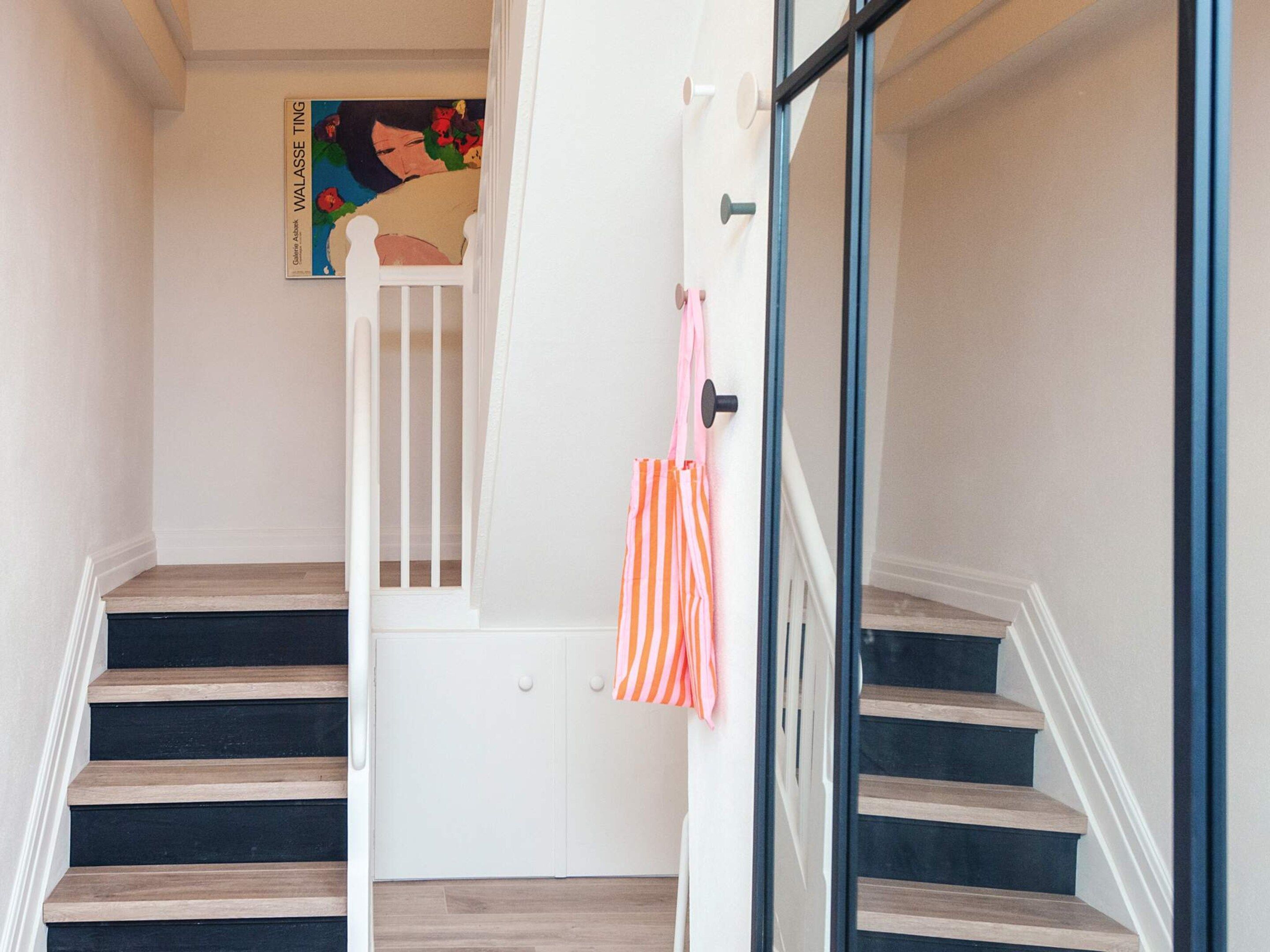A staircase with wooden steps and a white door at the top.