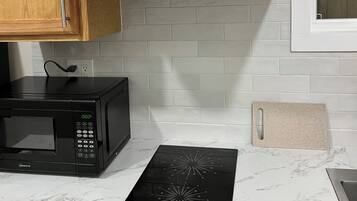 Fridge, microwave, coffee/tea maker, cookware/dishes/utensils