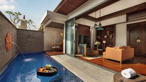 A modern indoor pool area with a dining setup, wooden furniture, and a view of the outdoors. - Avala Nusa Dua, Bali, a Tribute Portfolio Resort (Nusa Dua)