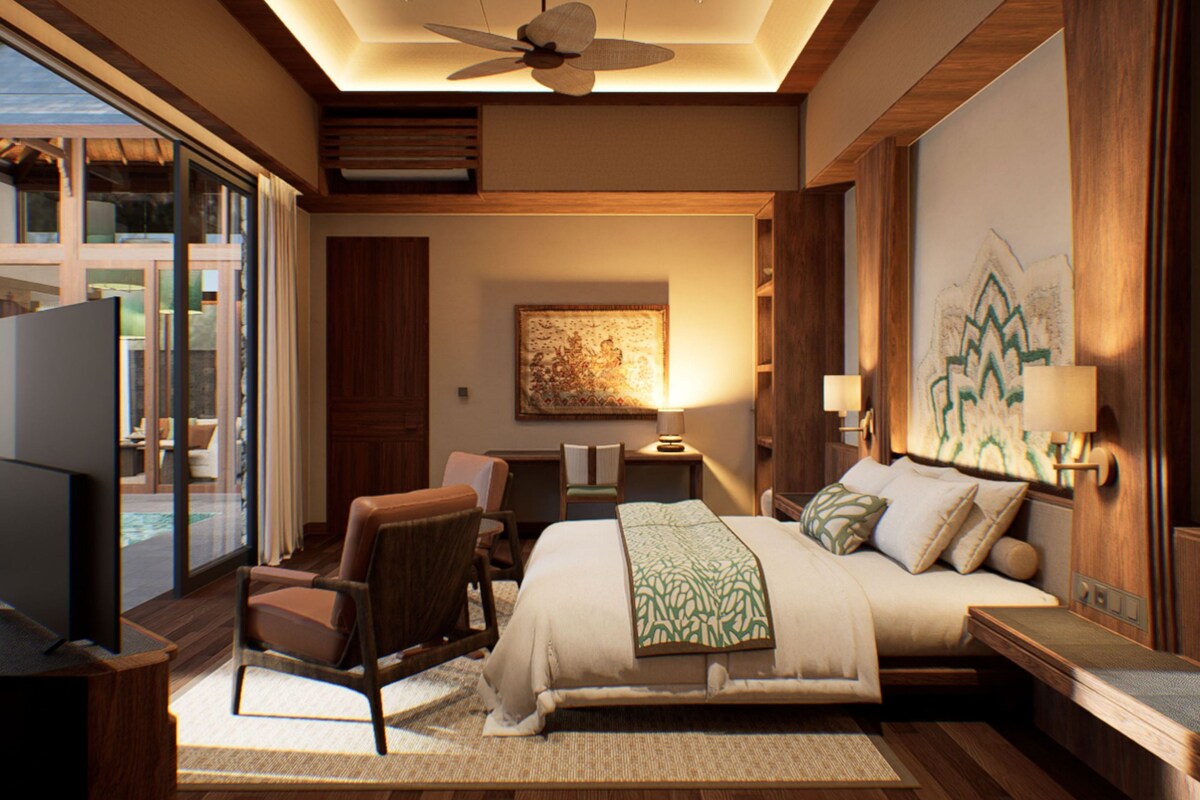 A modern hotel room with a large bed, a desk, a chair, a television, and a ceiling fan.