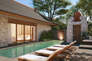 A modern house with a swimming pool, a bedroom with a large window, and a stone wall. - Avala Nusa Dua, Bali, a Tribute Portfolio Resort (Nusa Dua)