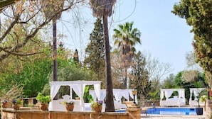 A poolside area with stone steps leading to a pool, surrounded by white canopies and potted plants. - Caragol 2 - Nature, XXL Pool, Yoga, AC (AG/6) (Manacor)
