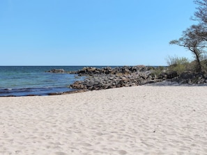 A sandy beach with rocky outcrops and sparse vegetation. - "Kirsti" - 300m from the sea by Interhome (Allinge)