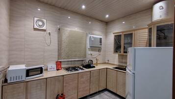 Family Suite, City View | Private kitchen