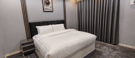 Family Suite, City View | Blackout drapes, iron/ironing board, free WiFi