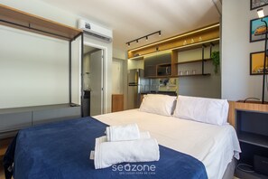 A hotel room with a bed, a wardrobe, a mirror, a shelf with decorative items, and a wall-mounted air conditioner. - Full Comfort Only 650m From the Metro Nxp1005 (São Paulo)