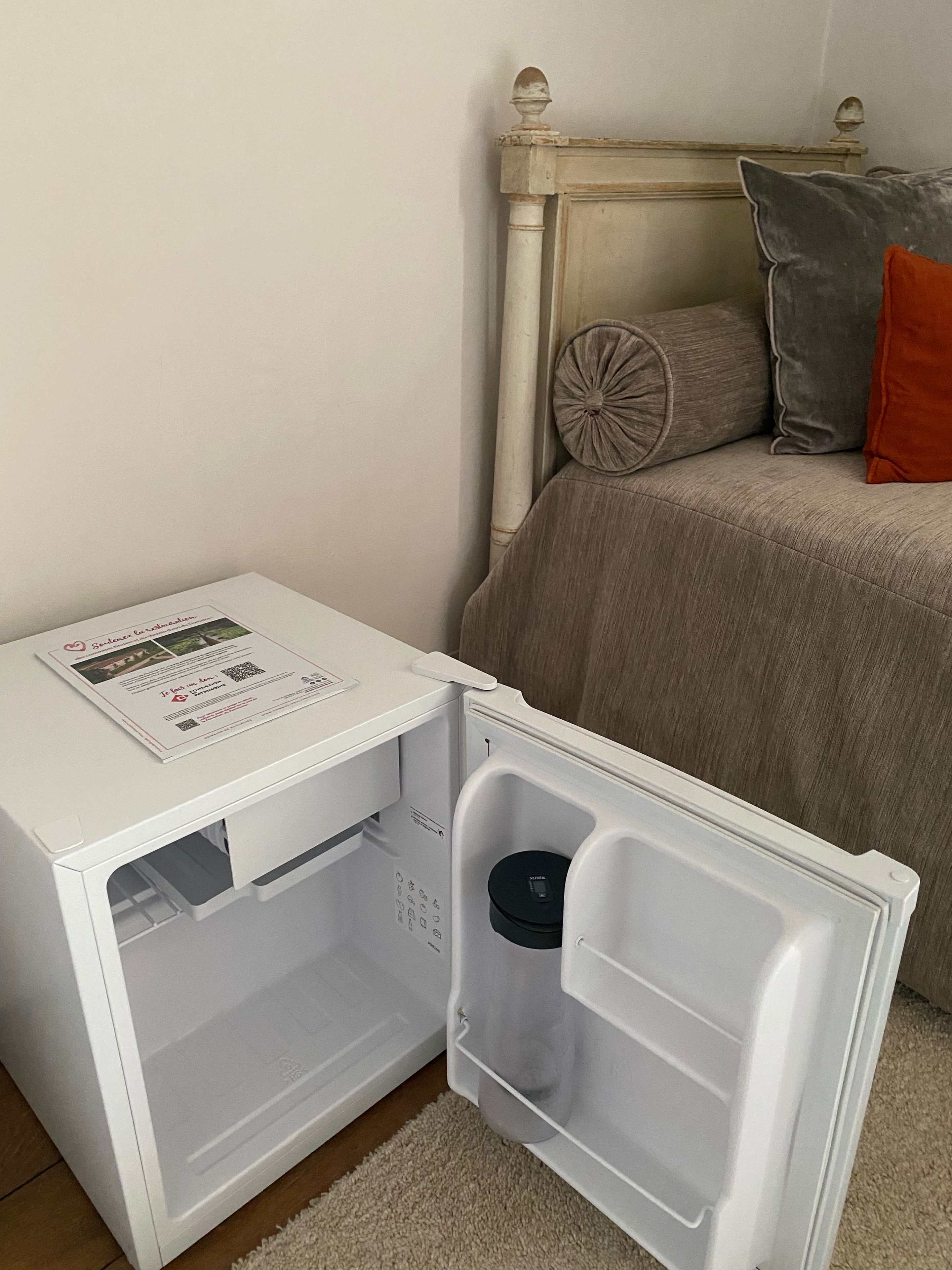 A compact refrigerator with a control panel, a small drawer, and a freezer compartment.