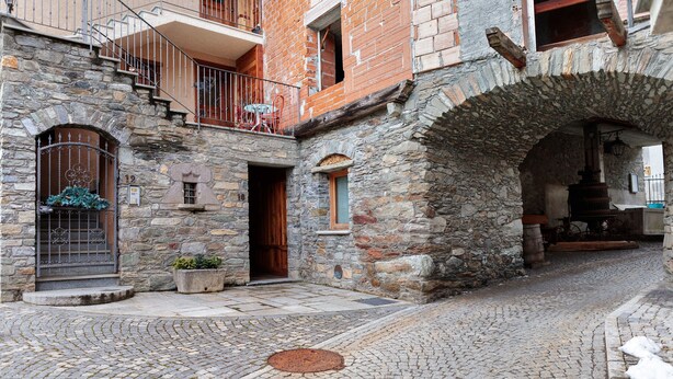 A cobblestone street with a stone building featuring a staircase, a door, and a window. - Casa Gardenia Apartment with Mountain View, Private Terrace and Wi-Fi (Rochefort)