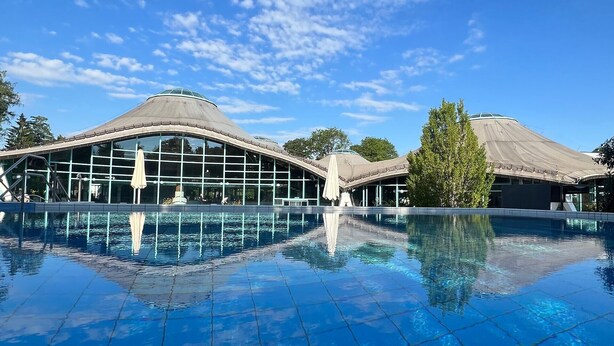 A modern building with a swimming pool in front, large windows, and a covered area. - Apartment Sieglinde with Private Terrace in Bad Dürrheim Öfingen (Bad Dürrheim)